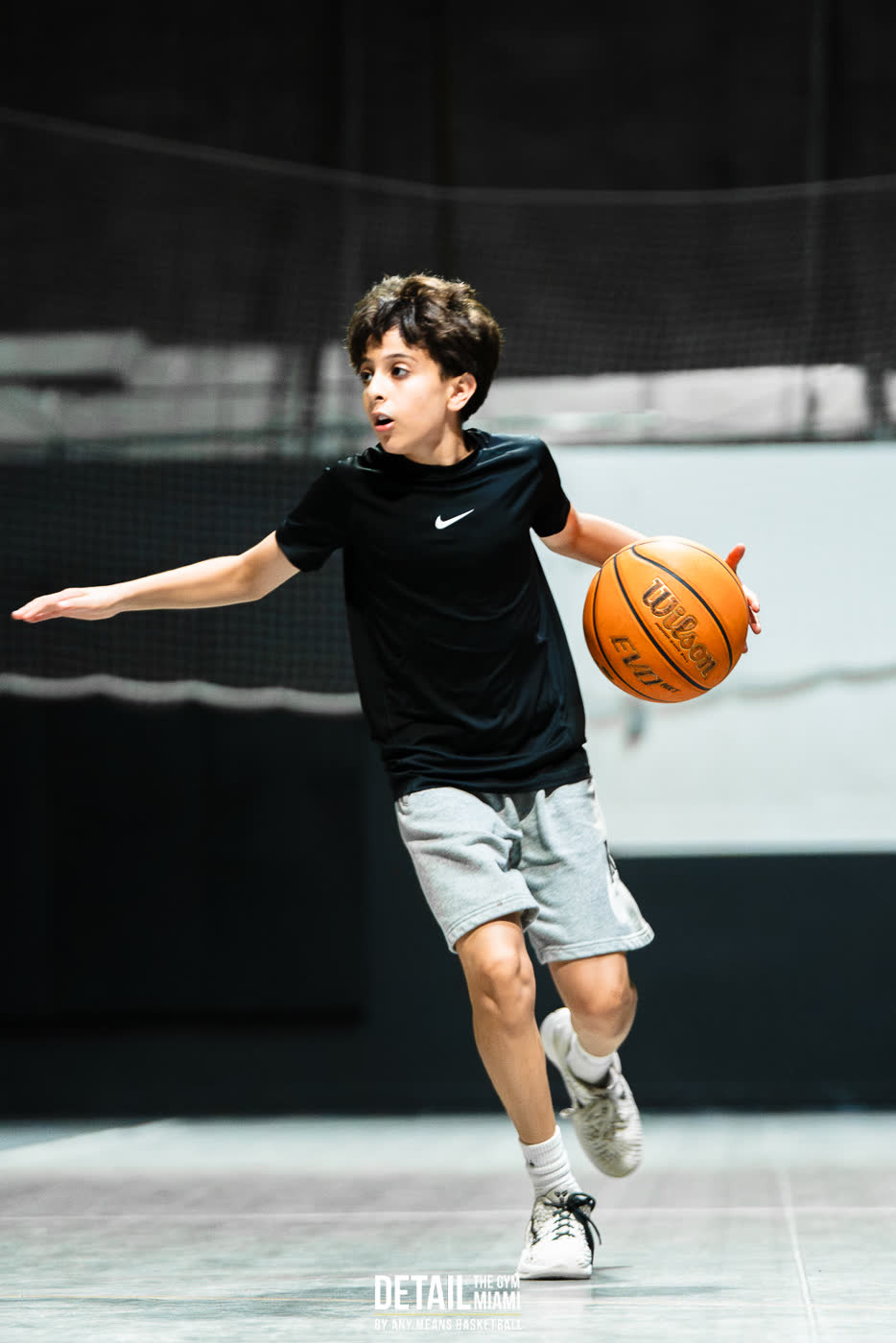 Young player dribbling with the right hand, left arm out to protect the ball, at DETAIL Miami